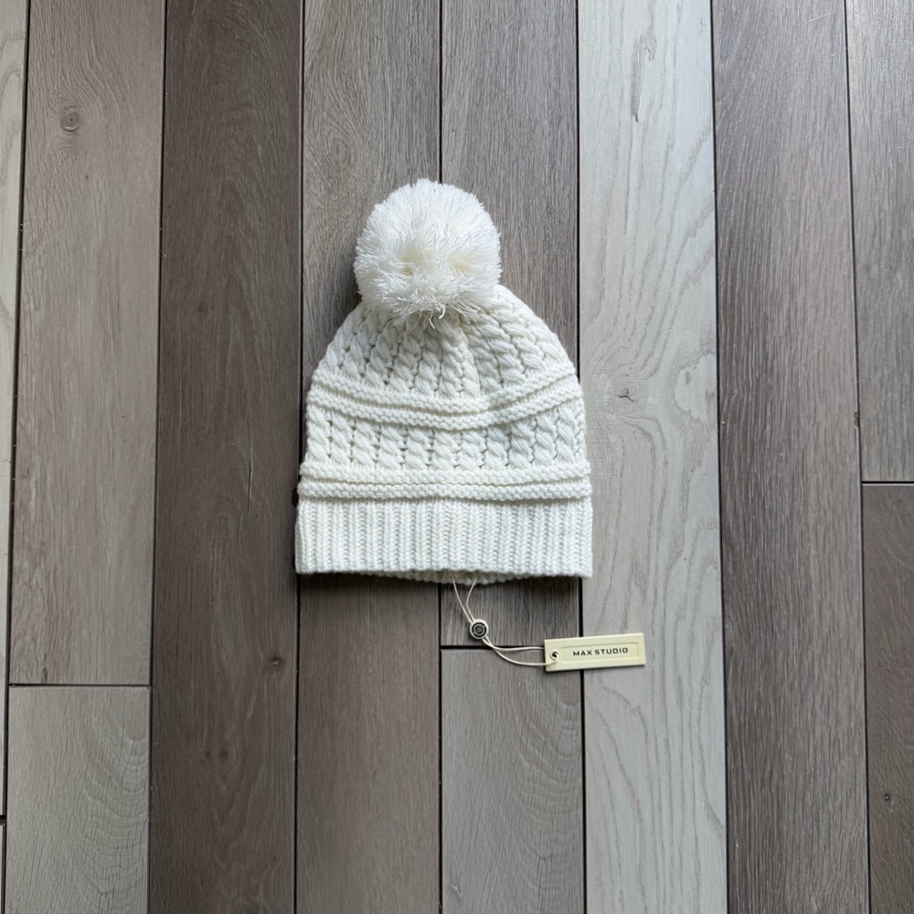 Max Studio ivory cable knit beanie with a pom-pom.